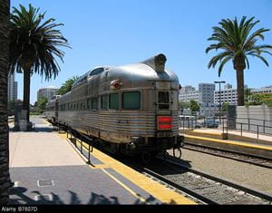 A silver Amtrak Zephyr train pulls into a station